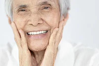 woman very happy with her new dental implants from Pocock Family Dental