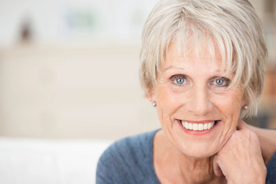 woman showing off her freshly restored smile