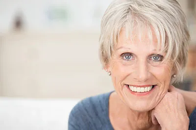 woman showing off her freshly restored smile