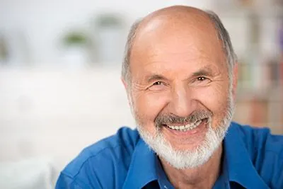 man smiling after getting restorative dental work done at Pocock Family Dental