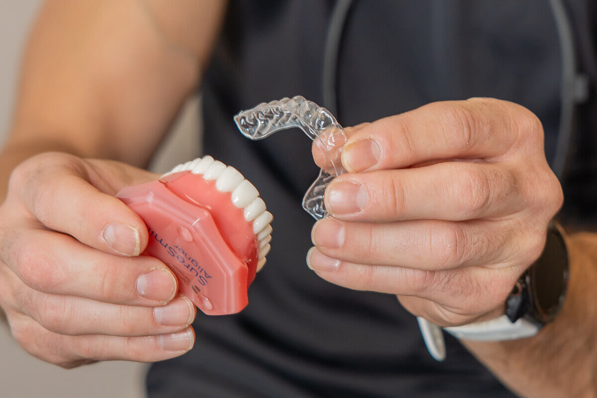 Staff member holding clear aligner at Pocock Family Dental in Twin Falls ID.