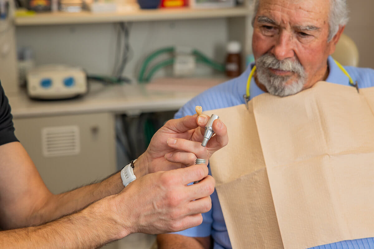 Staff member holding dental implant modal at Pocock Family Dental in Twin Falls ID.