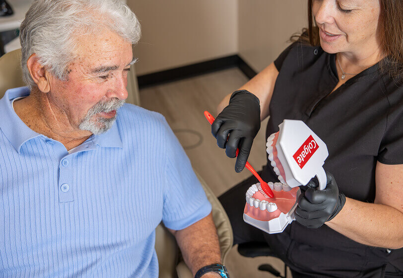 A senior patient being shown a 3d modal of teeth at Pocock Family Dental in Twin Falls ID.